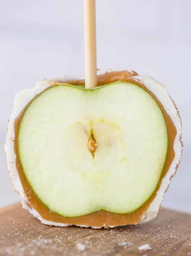 A caramel coated apple sliced in half.