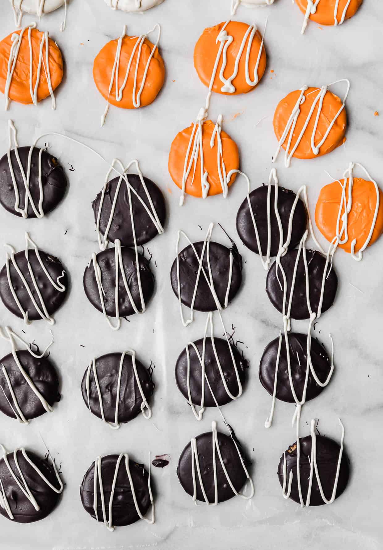 White chocolate drizzled overtop black and orange covered Halloween Crackers.