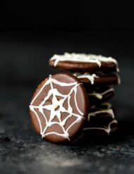 White chocolate spider web draw on a chocolate coated cracker.