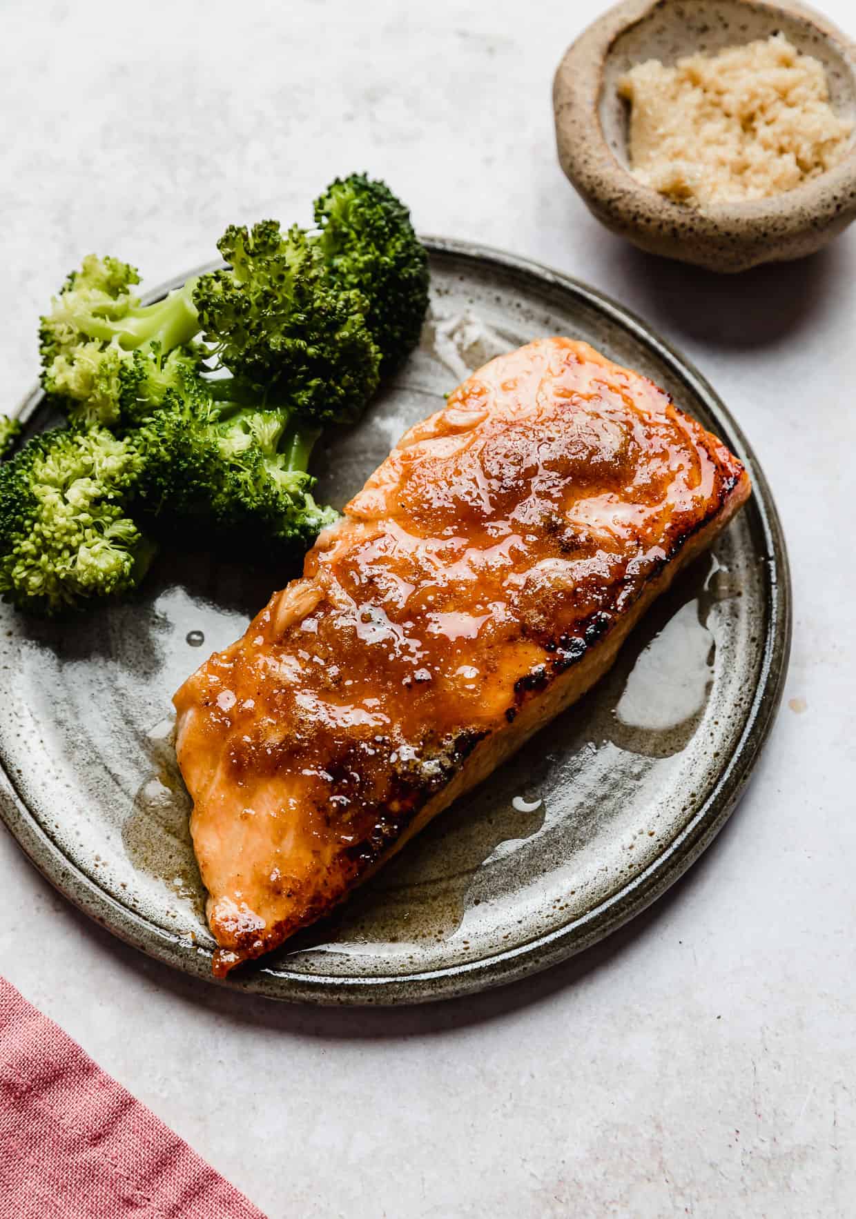 Brown Sugar Crusted Salmon and broccoli on a grey plate.