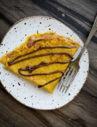 A pumpkin crepe stuffed with whipped Nutella and glazed with Nutella.