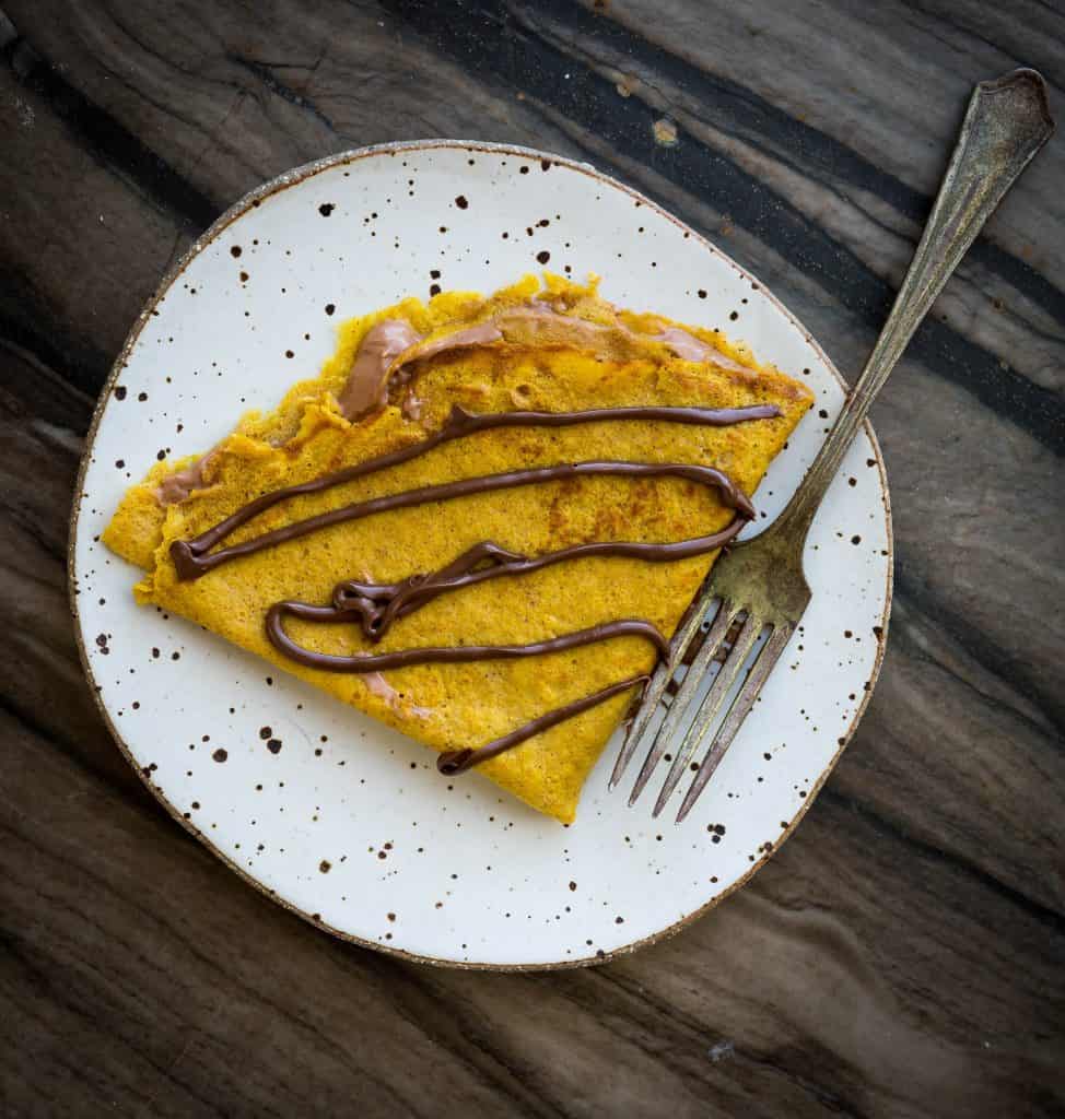 A pumpkin crepe stuffed with whipped Nutella and glazed with Nutella. 