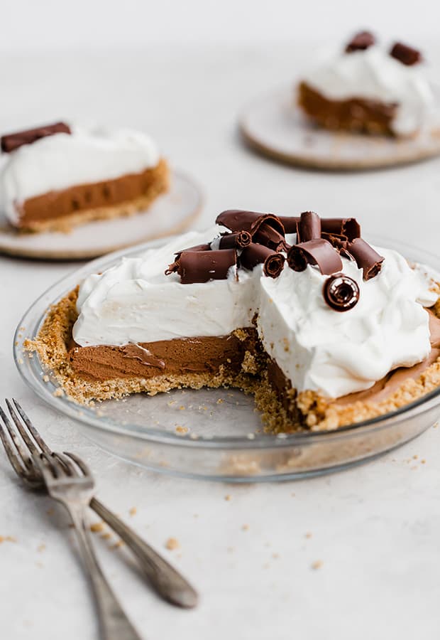 A French Silk Pie topped with whipped cream and homemade chocolate curls.