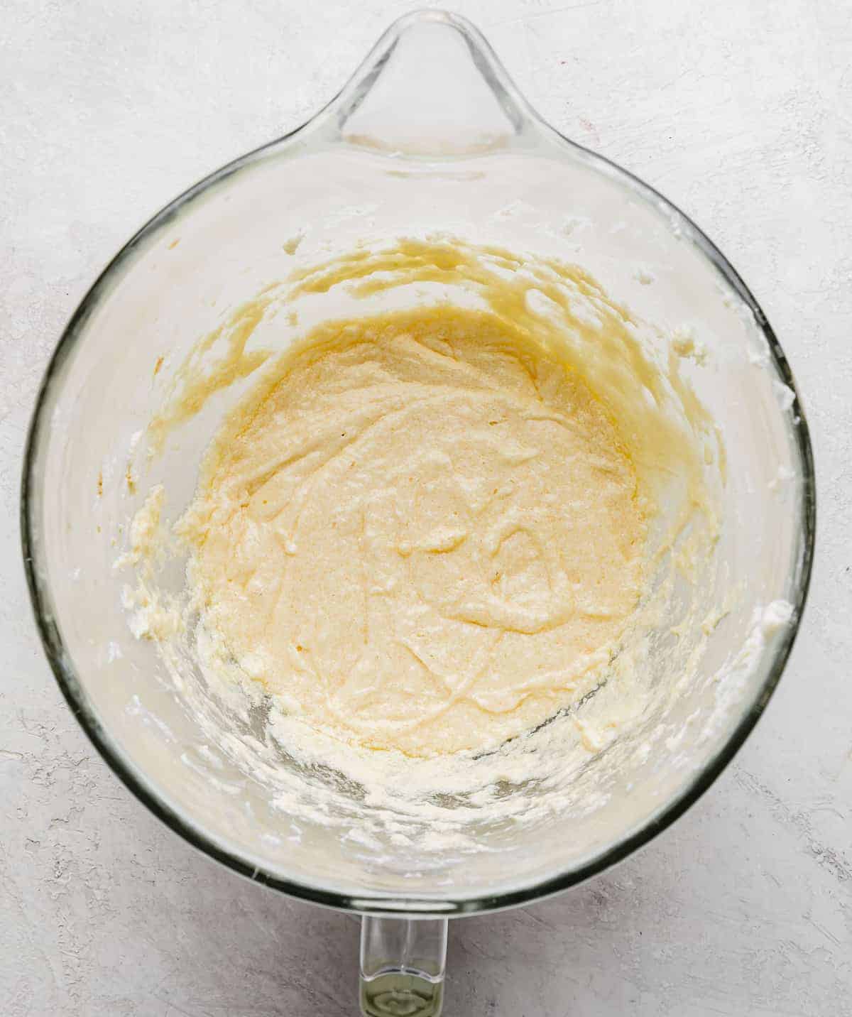 No Fail Sugar Cookies batter in a glass bowl on a gray background.