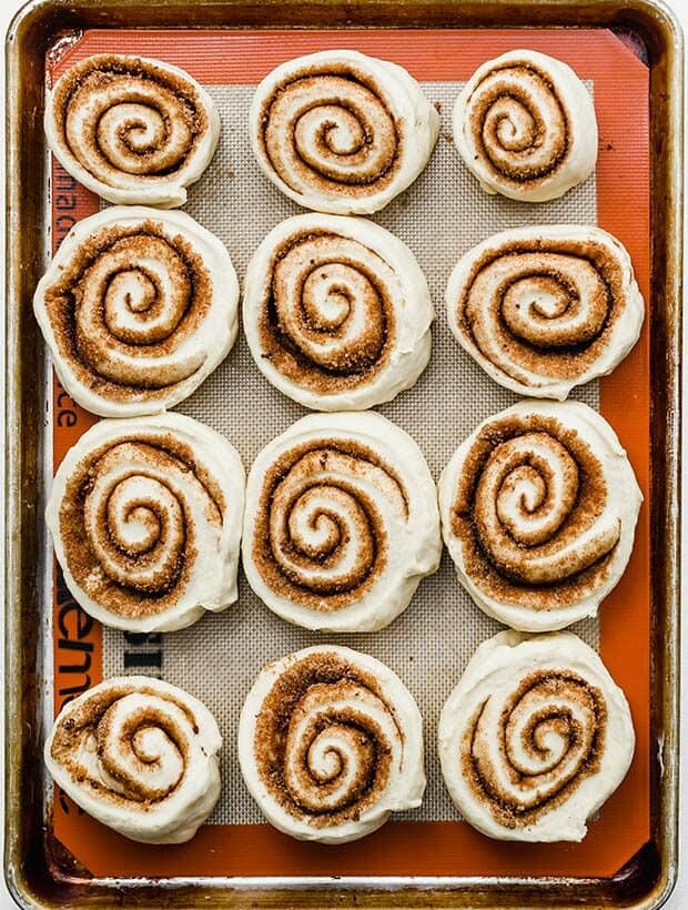 A baking sheet with 12 large cinnamon rolls.