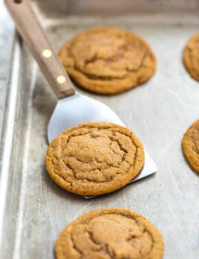 Soft gingersnap cookies on a baking sheet.