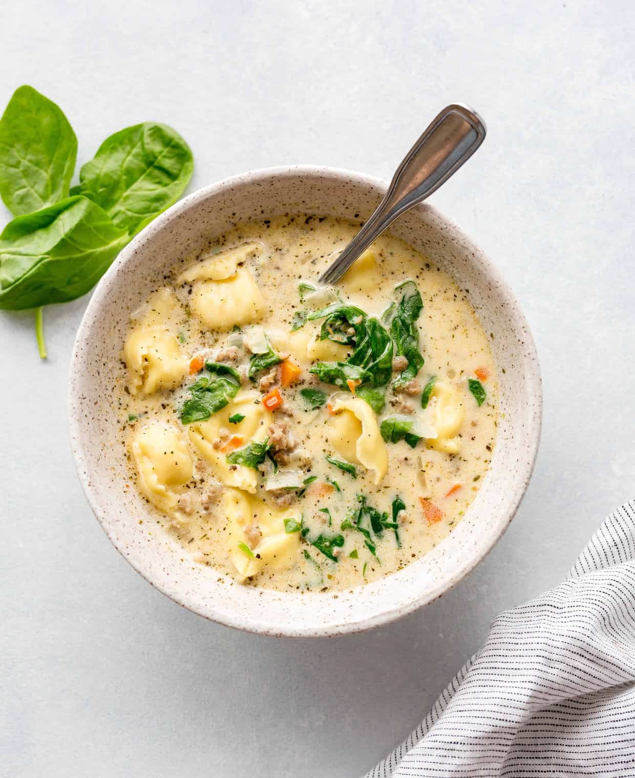 Bowl of sausage tortellini soup.