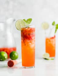 A mojito glass full of strawberry lime mojito drink.