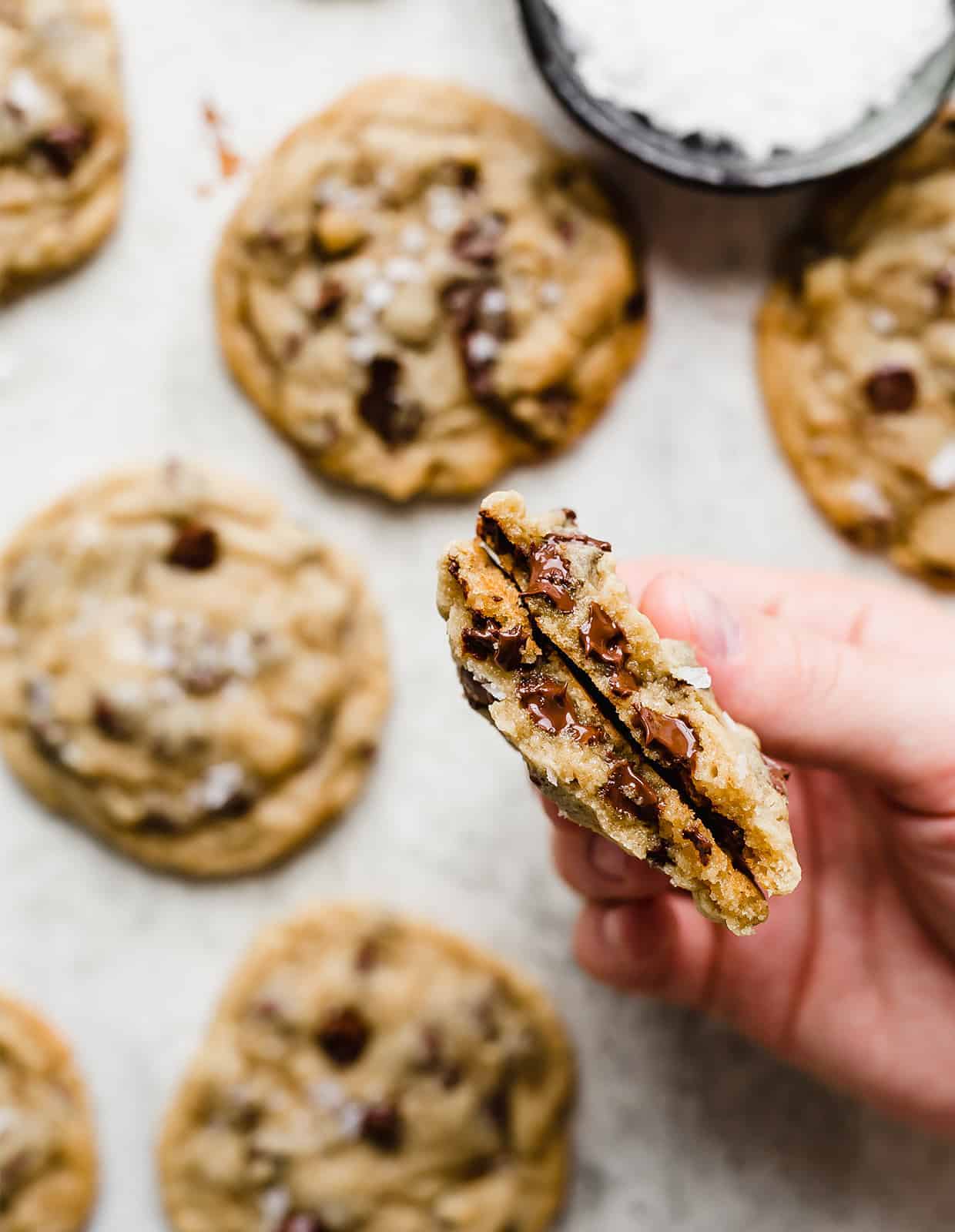 A chocolate chip cookie broken in half.