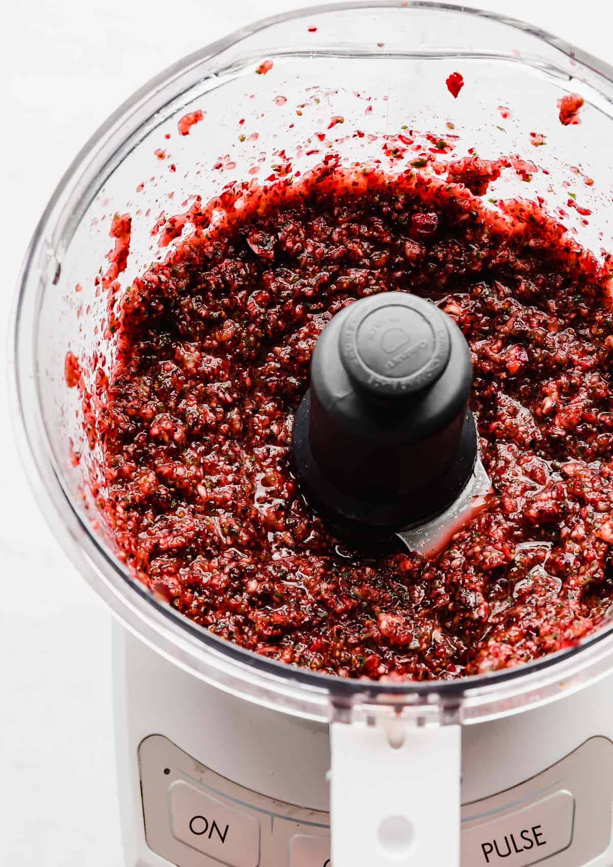 Pureed cranberry salsa in a food processor.