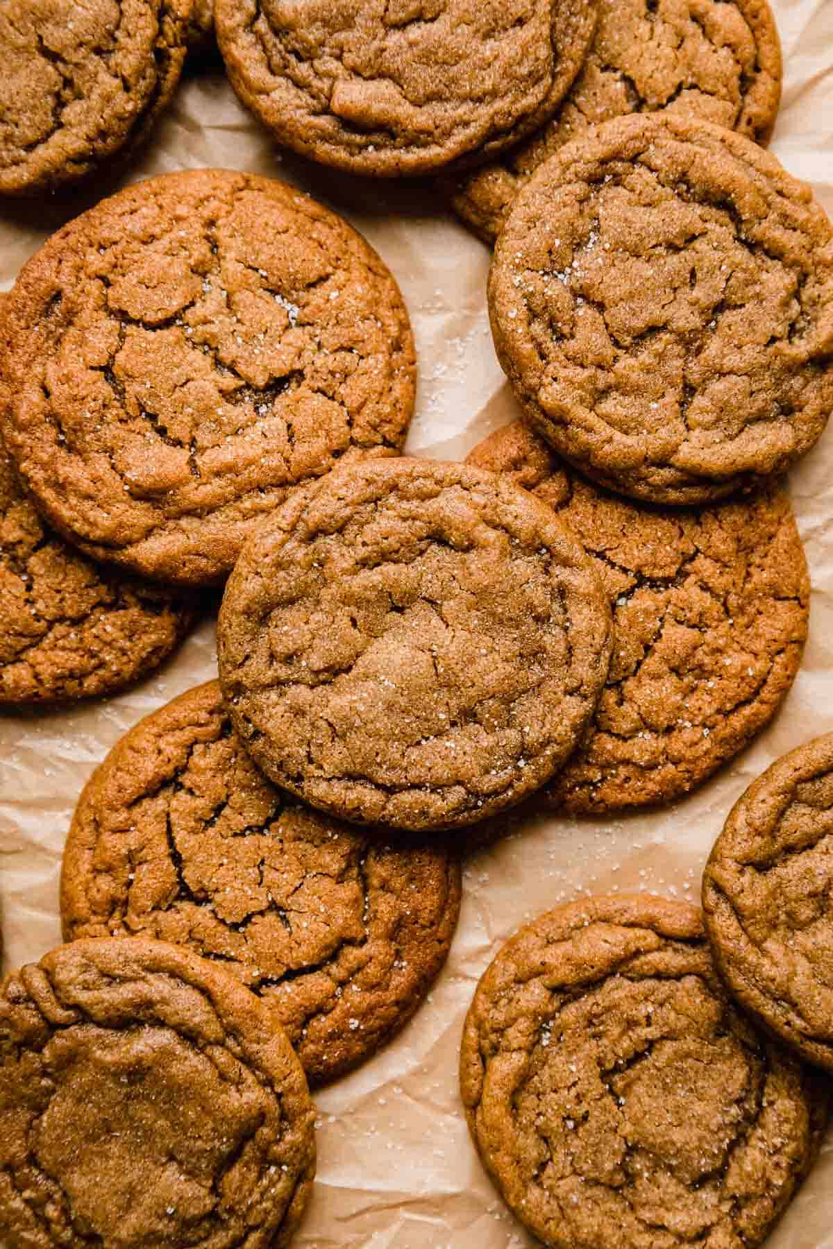 The best gingersnap cookies on a tan parchment paper.