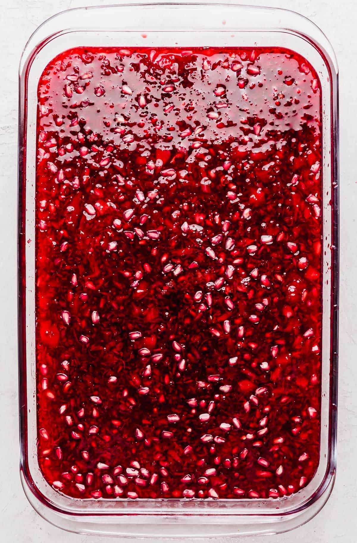 Pomegranate Jell-O in a rectangular glass dish.