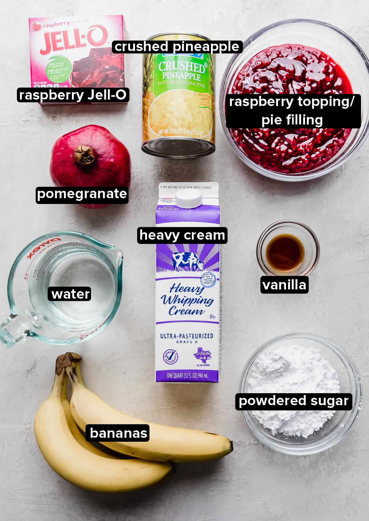 Pomegranate Jell-O ingredients laid out on a gray background.