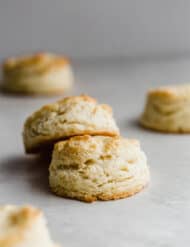 Two flaky buttermilk biscuits stacked on top of one another.