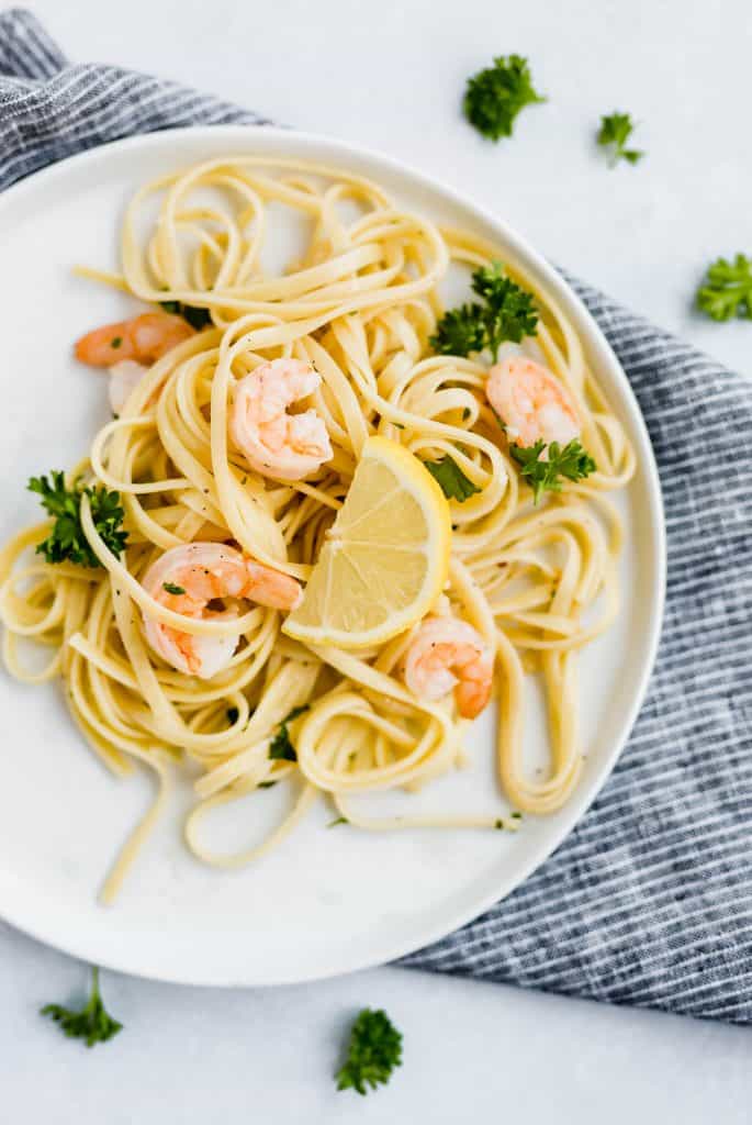 Shrimp Scampi with Linguini and a lemon wedge.