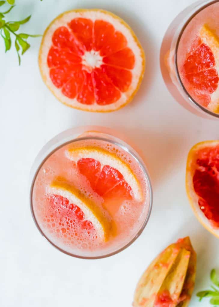 Overhead view of glasses full of Grapefruit Italian Soda.