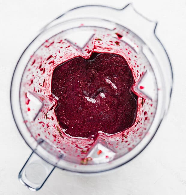 Overhead photo of an açaí smoothie in a blender cup.