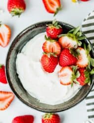 This Greek Yogurt Whipped Cream is beyond refreshing! Add strawberries, peaches, or the fruit of your choice and you have an easy and delicious dessert!