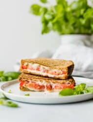 This Grilled Tomato, Mozzarella, and Pesto Sandwich is bursting with flavor! The pesto, mayo, and tomato make for an extra moist and juicy sandwich!