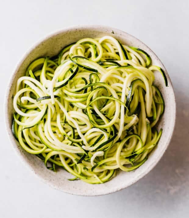 A pile of zucchini noodles in a bowl.