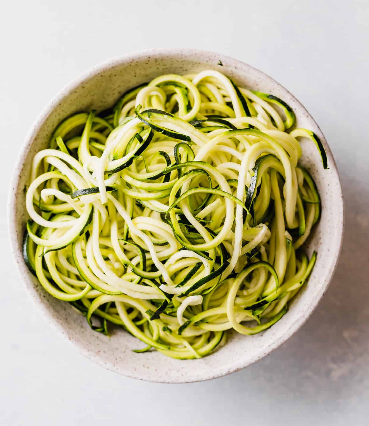 A pile of zucchini noodles in a bowl.