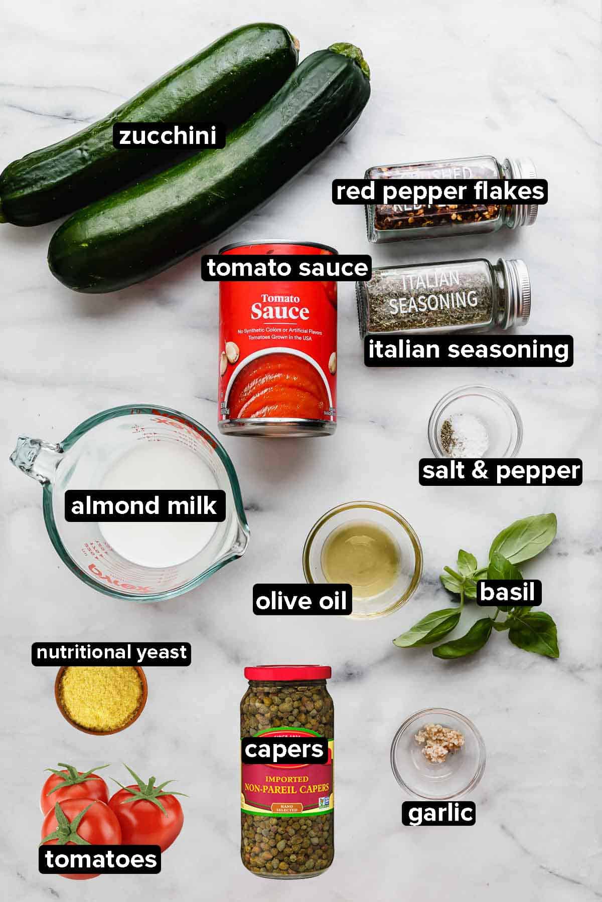 Zucchetti Pasta ingredients on a white marble background.