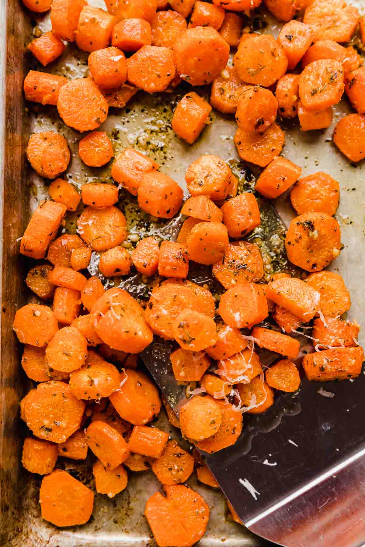 Sliced Garlic Butter Roasted Carrots on a baking sheet.