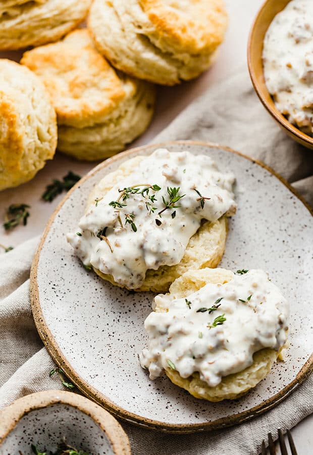 A buttermilk biscuit topped with a sausage gravy.