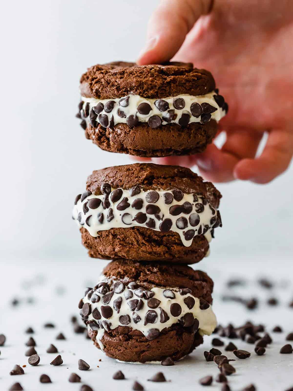 Three cookie ice cream sandwiches on top of each other.
