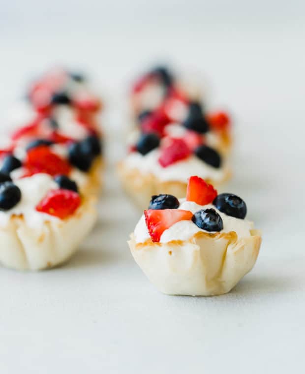 Greek yogurt whipped cream in Fillo shells topped with chopped strawberries and blueberries.