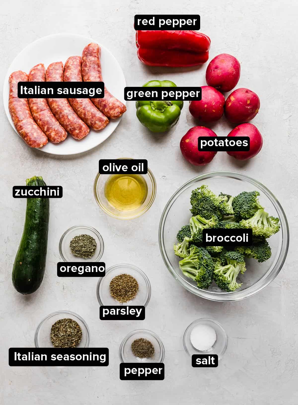 Sheet Pan Italian Sausage and Veggies ingredients on a gray background.