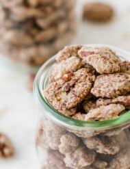 Candied pecans in a glass jar.