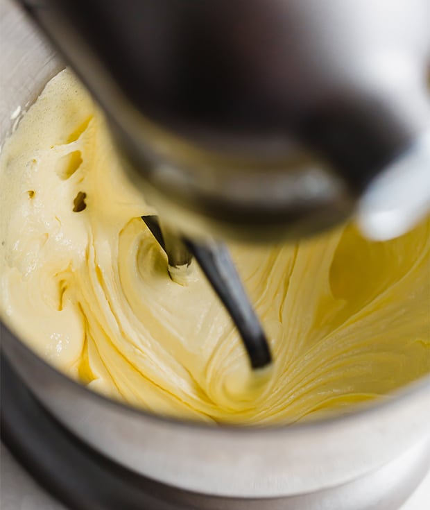A stand mixer beating the sugar and egg yolks until creamy.