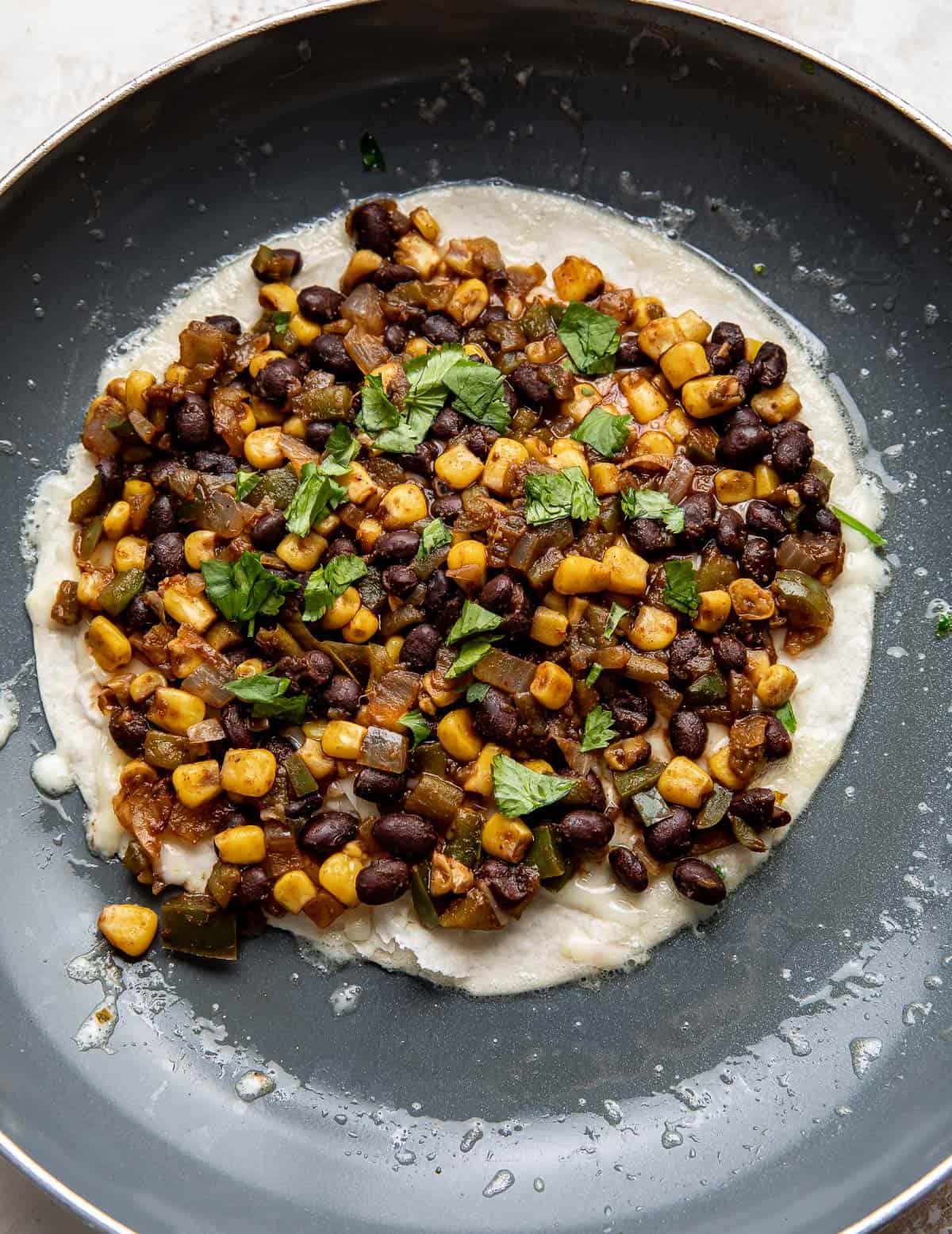 A tortilla topped with a Black Bean and Corn mixture.