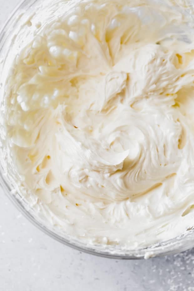 Cream cheese and mayonnaise whipped in a glass bowl. 