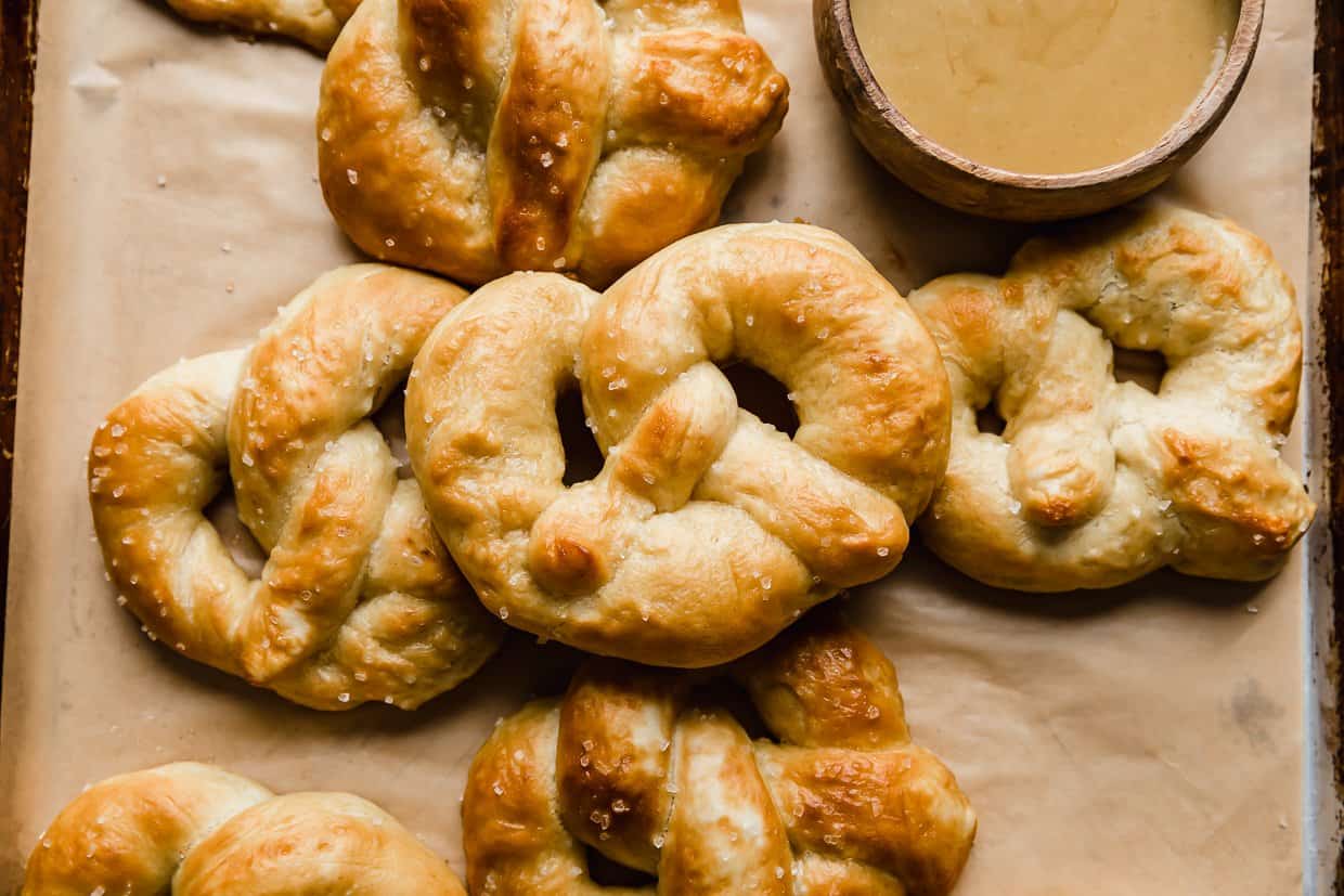 Homemade Soft Pretzels on a tan parchment paper.