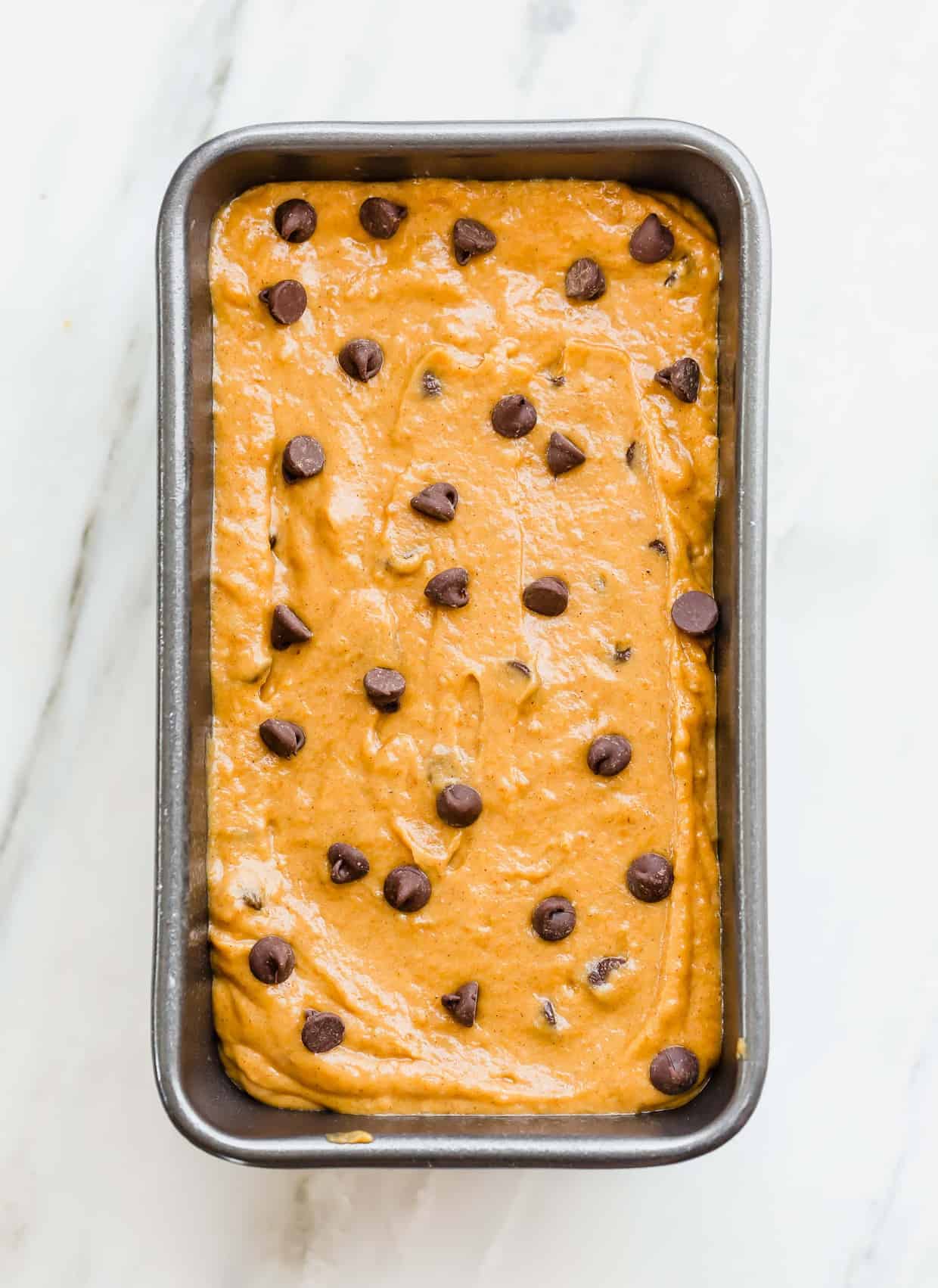 Overhead photo of pumpkin chocolate chip bread in a loaf pan.
