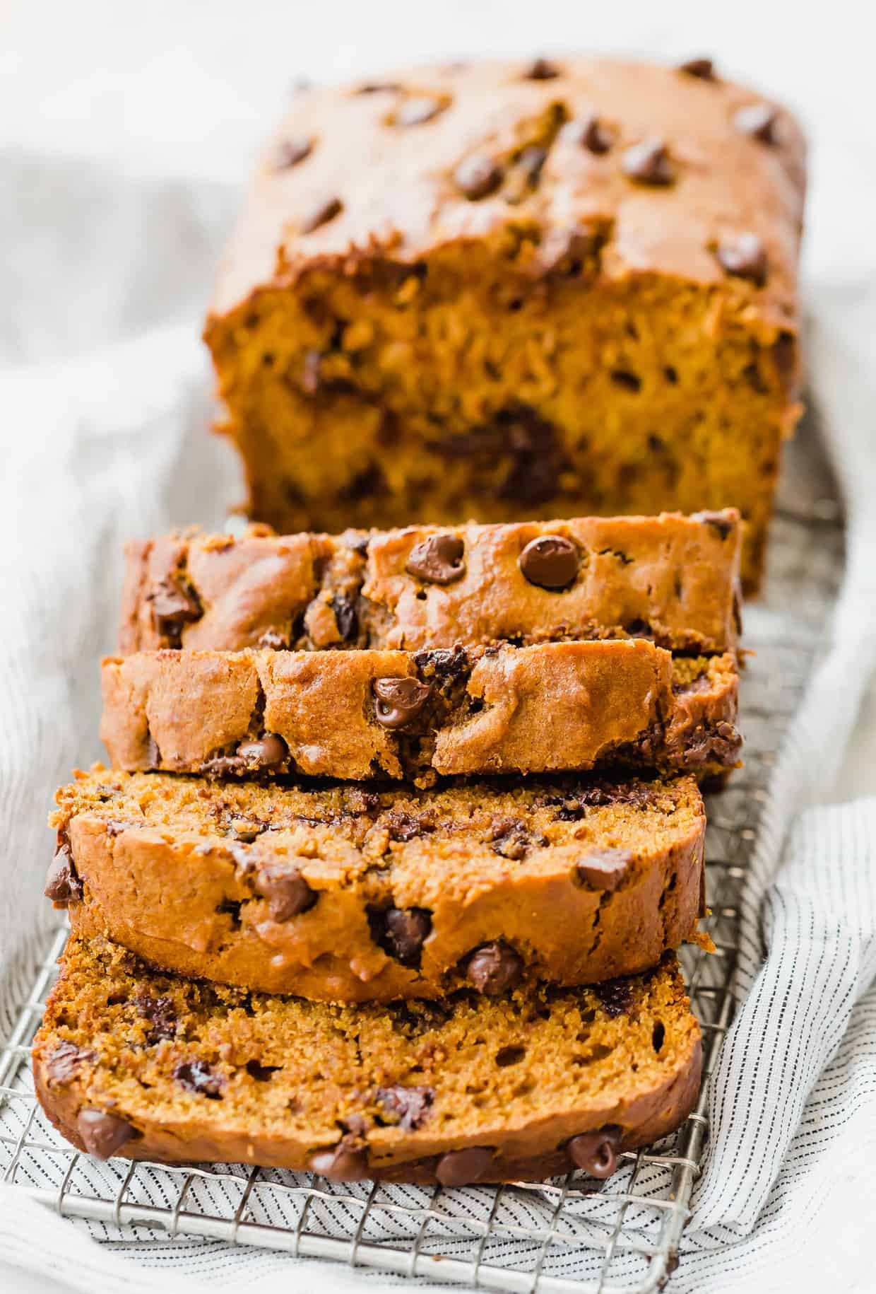 Pumpkin chocolate chip bread with 4 cut slices.