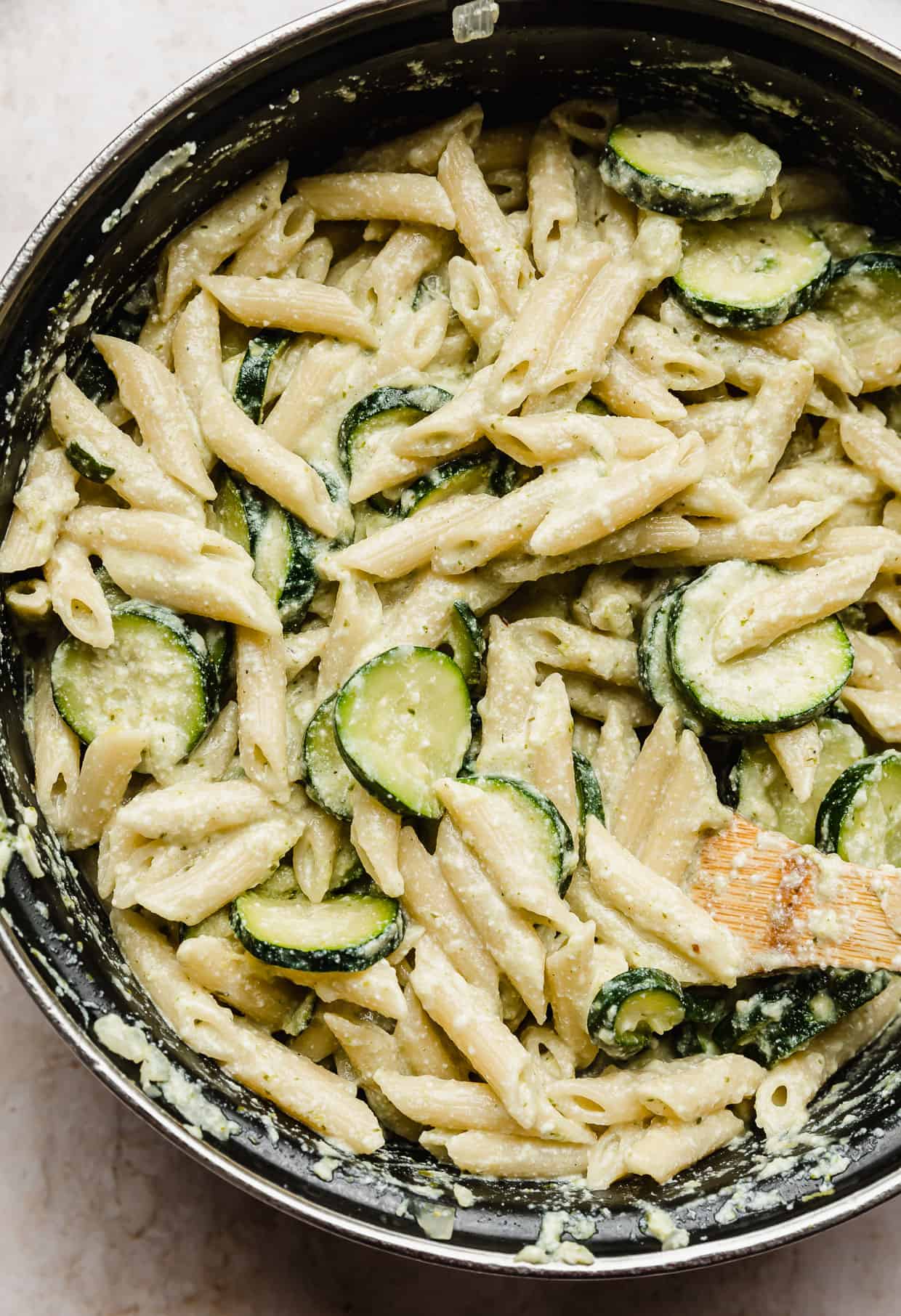 Pasta with Zucchini and Ricotta mixed together in a black pot.