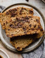 A slice of Chocolate Chip Zucchini Bread on a gray plate.