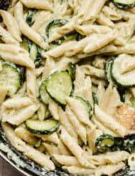 A close up photo of Pasta with Zucchini and Ricotta in a black pot.