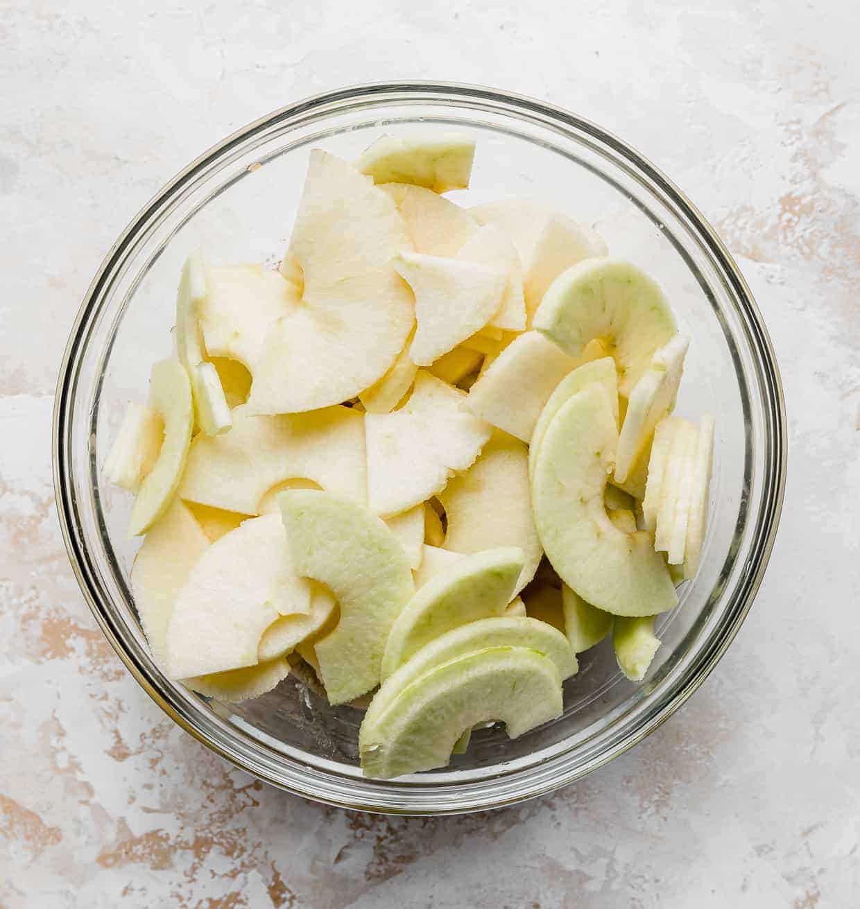 Sliced apples in a glass bowl.