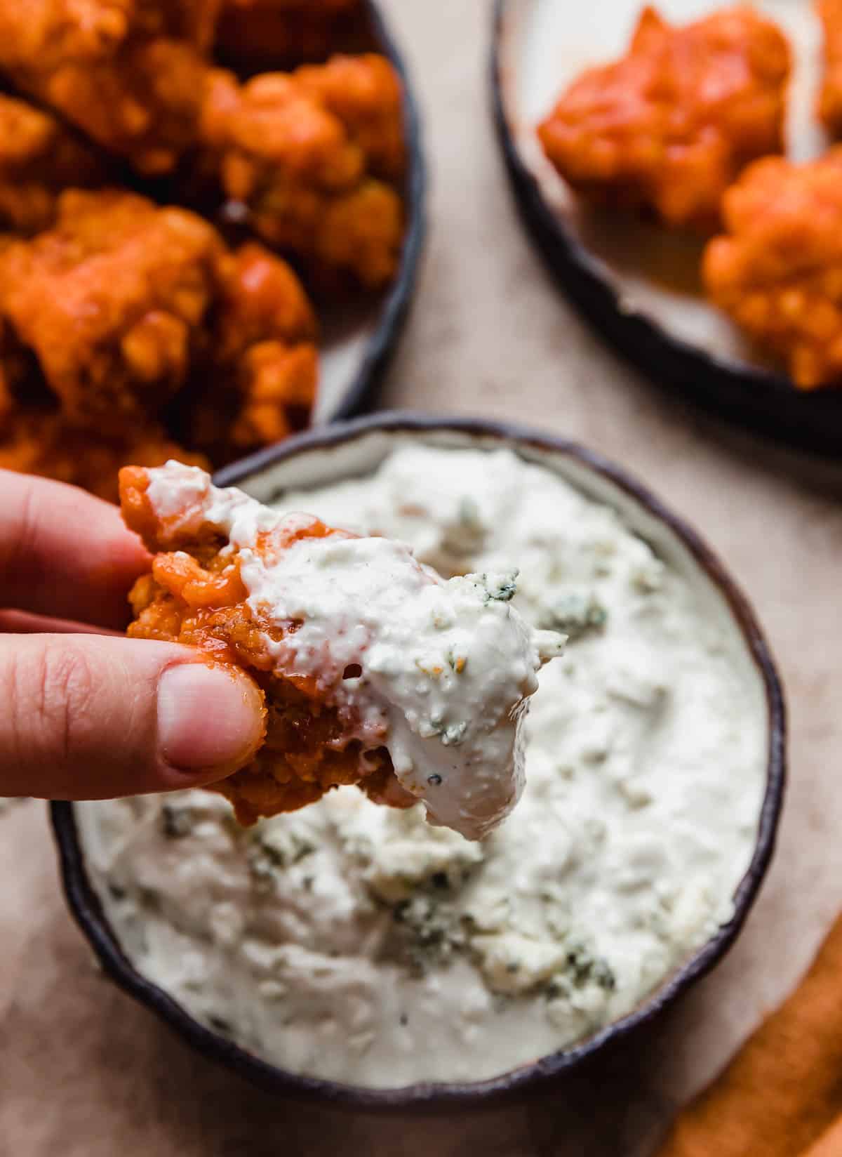A Buffalo Chicken Bite dipped in blue cheese sauce.