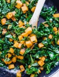 Diced butternut squash and chopped kale seasoned with pepper and chili powder.