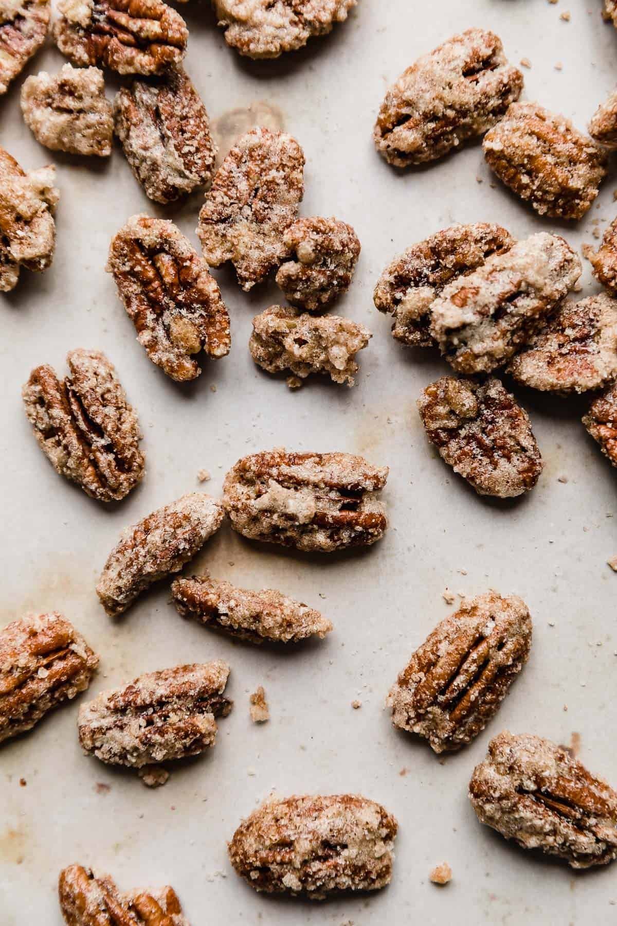 Roasted Candied Pecans on a tan background.