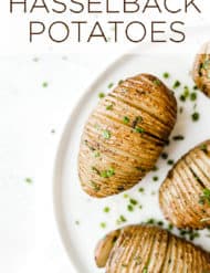 Hasselback Potatoes with a garnish of fresh chives.