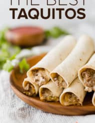 A stack of crispy taquitos on a brown plate.