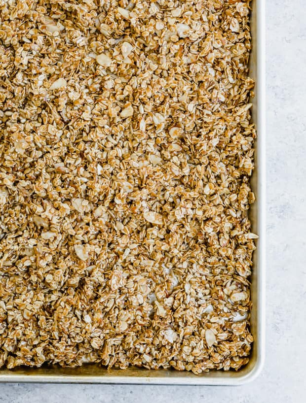 Homemade granola spread on a baking sheet.