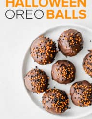 Oreo balls dipped in dark chocolate and covered in orange and black sprinkles.