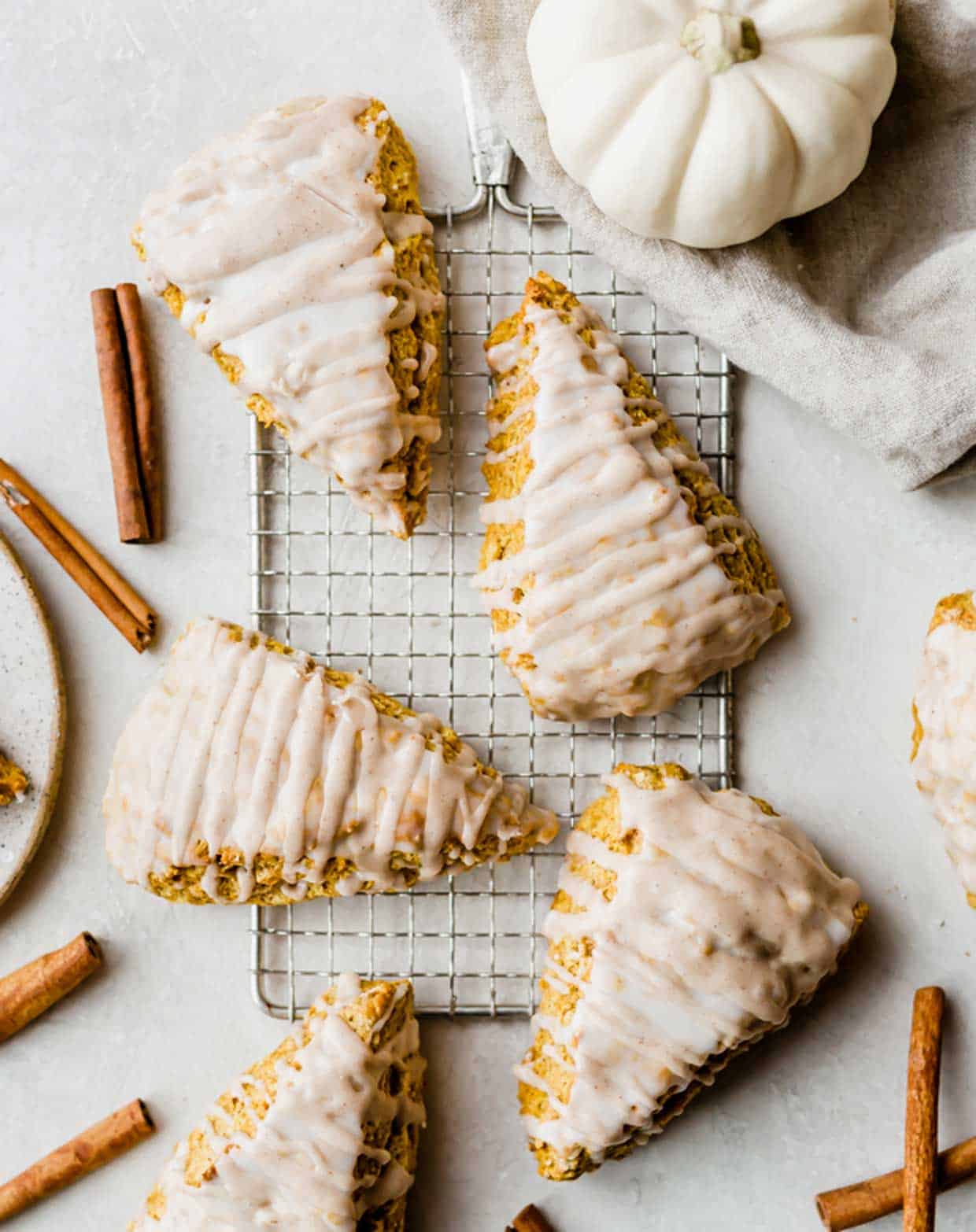 Overhead photo of triangular pumpkin scones topped with two glazes.